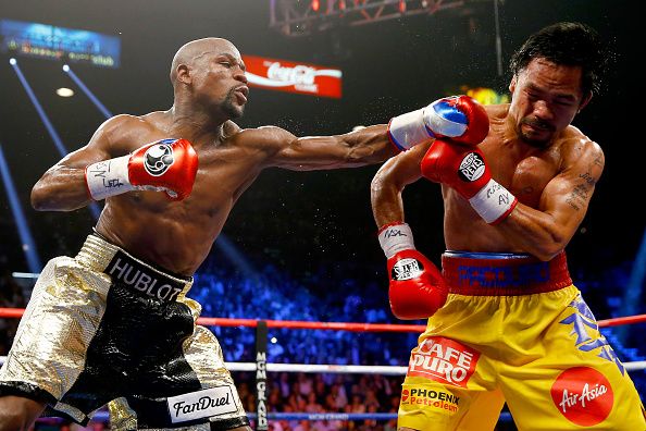 LAS VEGAS, NV - MAY 02:  Floyd Mayweather Jr. throws a left at Manny Pacquiao during their welterweight unification championship bout on May 2, 2015 at MGM Grand Garden Arena in Las Vegas, Nevada.  (Photo by Al Bello/Getty Images)