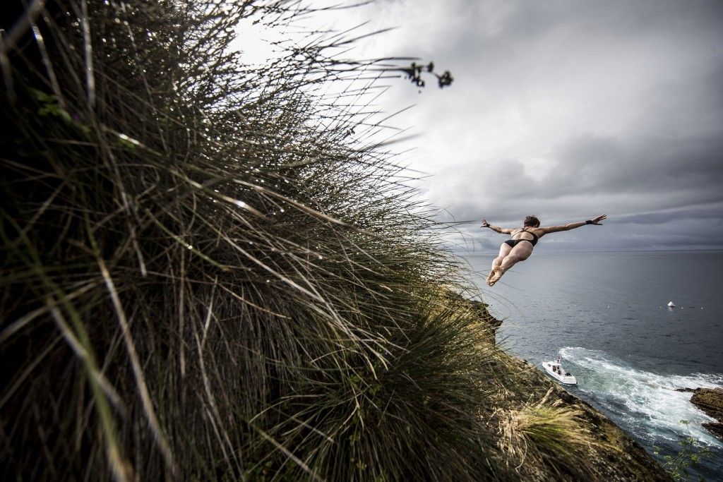 AZORES, PORTUGAL - JULY 17: (EDITORIAL USE ONLY) In this handout image provided by Red Bull, Ginger Huber of the USA dives from a 20 metre cliff during the first round of the fifth stop of the Red Bull Cliff Diving World Series on July 17, 2015 at Islet Franca do Campo, Azores, Portugal. (Photo by Dean Treml/Red Bull via Getty Images)
