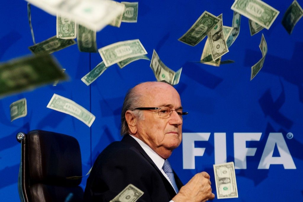 ZURICH, SWITZERLAND - JULY 20: Comedian Simon Brodkin (not pictured) throws dollar bills at FIFA President Joseph S. Blatter during a press conference at the Extraordinary FIFA Executive Committee Meeting at the FIFA headquarters on July 20, 2015 in Zurich, Switzerland. (Photo by Philipp Schmidli/Getty Images)