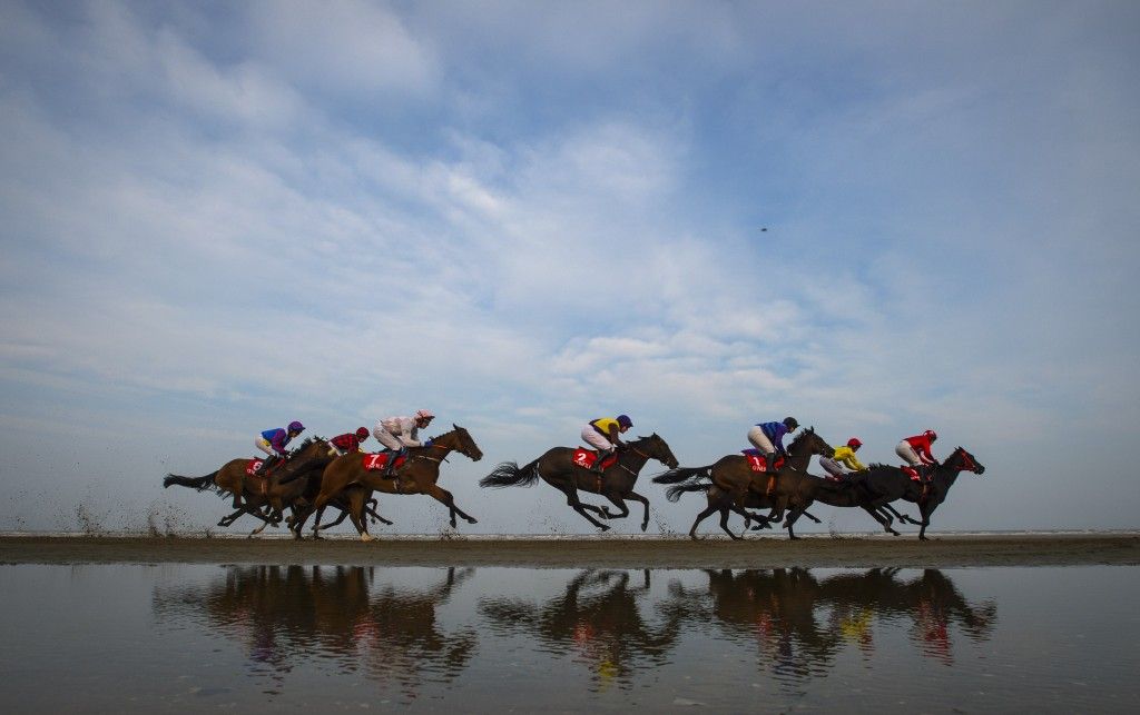 MEATH, IRELAND - SEPTEMBER 10: Runners and riders compete at the Laytown races during the one day annual meet on September 10, 2015 in Meath, Ireland. Laytown races held once a year and first raced in 1868 occupies a unique position in the Irish racing calendar as it is the only race event run on a beach under the Rules of Racing. (Photo by Justin Setterfield/Getty Images)