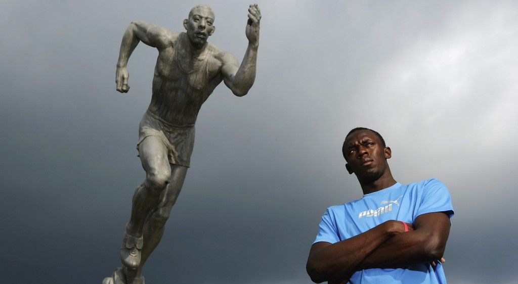 KINGSTON, JAMAICA - OCTOBER 17: Usain Bolt, the 200m and 400m sprinter poses in front of 'The Sprinter' statue at the National Stadium on October 17, 2006 in Kingston, Jamaica. (Photo by Michael Steele/Getty Images)