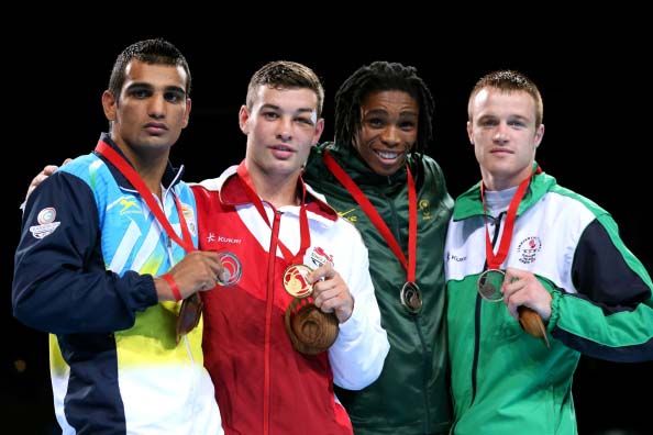 GLASGOW, SCOTLAND - AUGUST 02: Scott Fitzgerald (2ndL) of England poses with silver medalist Mandeep Jangra (L) of India and bronze medalists Tulani Mbenge of South Africa and Steven Donnelly of Northern Ireland during the medal ceremony for the Men's Welter (69kg) Final at SSE Hydro during day ten of the Glasgow 2014 Commonwealth Games on August 2, 2014 in Glasgow, Scotland. (Photo by Alex Livesey/Getty Images)