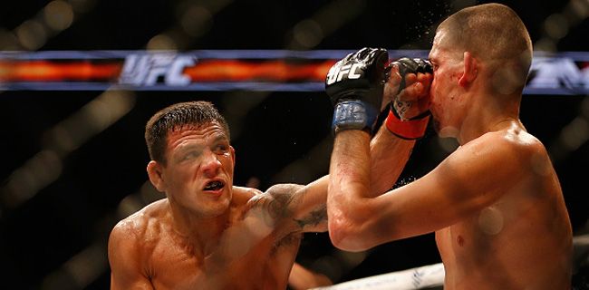 PHOENIX, AZ - DECEMBER 13: Rafael dos Anjos (L) punches Nate Diaz in their heavyweight bout during the UFC Fight Night event at the at U.S. Airways Center on December 13, 2014 in Phoenix, Arizona. (Photo by Christian Petersen/Getty Images)