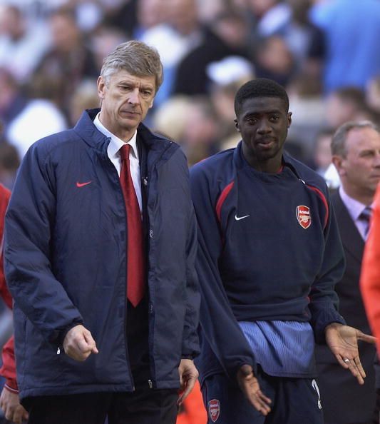 Arsenal manager Arsene Wenger looks dejected as he leaves the field with Kolo Toure of Arsenal