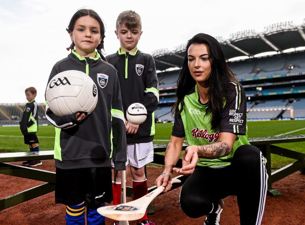12 April 2016; TV star Moone Boy, David Rawle, joined a host of GAA stars today at Croke Park to launch Kellogg’s GAA Cúl Camps 2016. The summer camps attract over 100,000 children and are hosted in more than 1,000 locations nationwide. Costing just Ä55 for a full week of fun, coaching and a free kit, Kellogg’s is on a mission for the promotion of nutrition coupled with physical activity. Sign up for Kellogg’s GAA Cúl Camps at www.kelloggsculcamps.gaa.ie. Pictured is Cork camogie player with children from Gaelscoil Cholaiste Mhuire. Croke Park, Dublin. Picture credit: Ramsey Cardy / SPORTSFILE