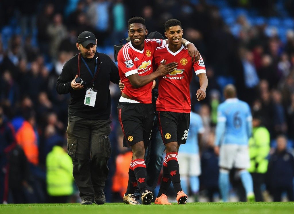 MANCHESTER, ENGLAND - MARCH 20: Winning goalscorer Marcus Rashford of Manchester United (R) and team mate Timothy Fosu-Mensah celebrate victory after the Barclays Premier League match between Manchester City and Manchester United at Etihad Stadium on March 20, 2016 in Manchester, United Kingdom. (Photo by Laurence Griffiths/Getty Images)