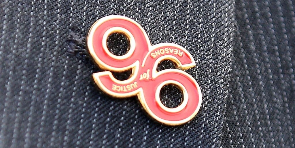 WARRINGTON, ENGLAND - APRIL 26: A relative arrives, wearing a 'Justice for the 96' button badge, at Birchwood Park to hear the verdict of the Hillsborough inquest on April 26, 2016 in Warrington, England. The fresh inquests into the 1989 Hillsborough disaster, in which 96 football supporters were crushed to death, began on March 31 2014 after the initial verdicts were quashed. Relatives of Liverpool supporters who died in Britain's worst sporting disaster gathered in the purpose-built court to hear the jurys verdict in Warrington after a 25 year fight to overturn the accidental death verdicts handed down at the initial 1991 inquiry. (Photo by Christopher Furlong/Getty Images)