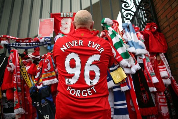 LIVERPOOL, ENGLAND - APRIL 15: Liverpool fans pay their respects at the Hillsborough memorial at Anfield on April 15, 2009, Liverpool, England. Thousands of fans, friends and relatives are descending on Liverpool's Anfield Stadium to mark the 20th anniversary of the Hillsborough disaster. A total of 96 Liverpool supporters lost their lives during a crush at an FA Cup semi final against Nottingham Forest at the Hillsborough football ground in Sheffield, South Yorkshire in 1989. (Photo by Christopher Furlong/Getty Images)