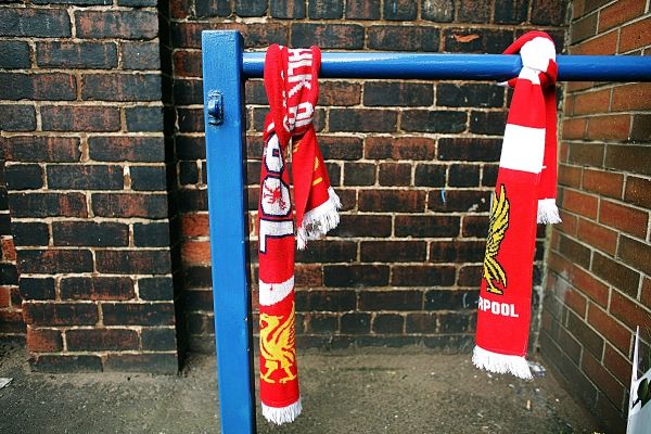 SHEFFIELD, ENGLAND - APRIL 14: Floral tributes and Liverpool scarves lay in tribute next to the Leppings Lane entrance of Hillsborough Stadium on the eve of the 20th anniversary of the Hillsborough disaster on April 14, 2009, Sheffield, England. Sheffield Wednesday FC are not holding an official service to mark the disaster but will be opening the Leppings lane end for people wishing to pay their respects. A total of 96 Liverpool supporters lost their lives during a crush at an FA Cup semi final against Nottingham Forest at the Hillsborough football ground in Sheffield, South Yorkshire on April 15, 1989. (Photo by Christopher Furlong/Getty Images)