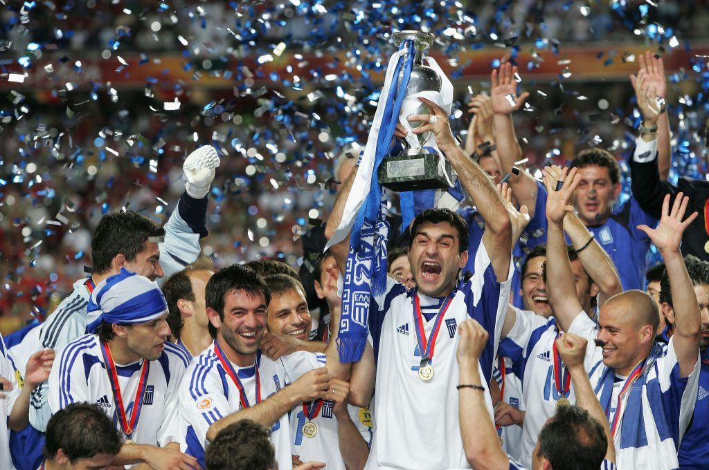LISBON, PORTUGAL - JULY 4: Traianos Dellas of Greece lifts the trophy during the UEFA Euro 2004 Final match between Portugal and Greece at the Luz Stadium on July 4, 2004 in Lisbon, Portugal. (Photo by Alex Livesey/Getty Images)