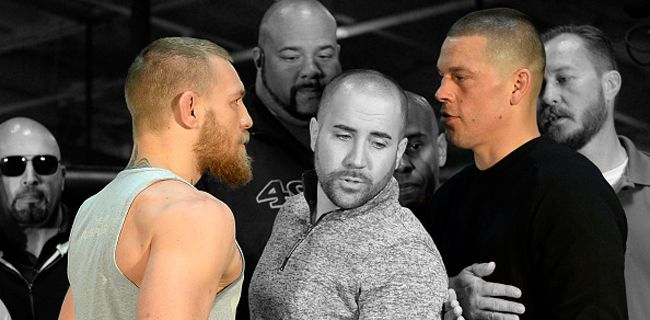 TORRANCE, CA - FEBRUARY 24: UFC featherweight champion Conor McGregor (L) and lightweight contender Nate Diaz (R) are held apart by Dave Sholler (C), UFC vice president of public relations, after a news conference at UFC Gym February 24, 2016, in Torrance, California. (Photo by Kevork Djansezian/Getty Images)