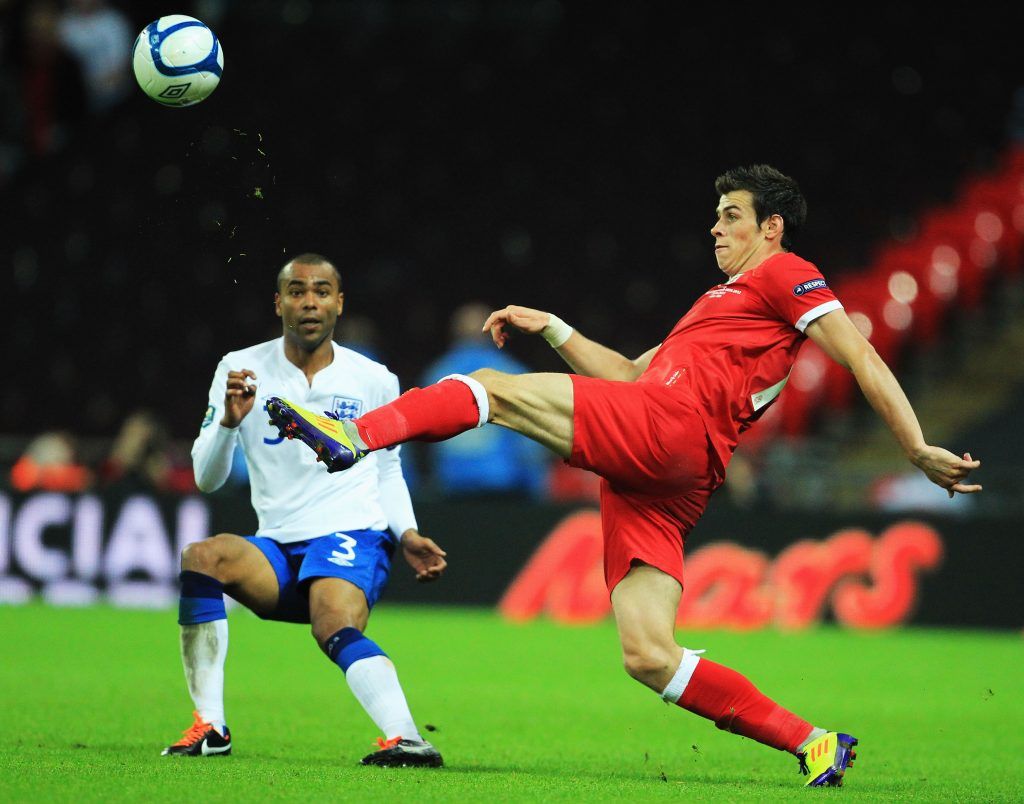 LONDON, ENGLAND - SEPTEMBER 06: Gareth Bale (R) of Wales clears the ball ahead of Ashley Cole of England during the UEFA EURO 2012 group G qualifying match between England and Wales at Wembley Stadium on September 6, 2011 in London, England. (Photo by David Cannon/Getty Images)