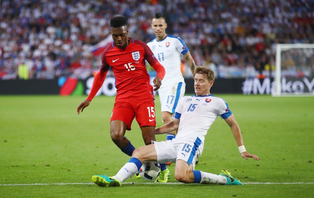 SAINT-ETIENNE, FRANCE - JUNE 20: Daniel Sturridge of England is tackled by Tomas Hubocan of Slovakia during the UEFA EURO 2016 Group B match between Slovakia and England at Stade Geoffroy-Guichard on June 20, 2016 in Saint-Etienne, France. (Photo by Clive Brunskill/Getty Images)