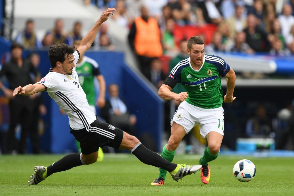 PARIS, FRANCE - JUNE 21: Conor Washington of Northern Ireland is tackled by Mats Hummels of Germany during the UEFA EURO 2016 Group C match between Northern Ireland and Germany at Parc des Princes on June 21, 2016 in Paris, France. (Photo by Shaun Botterill/Getty Images)