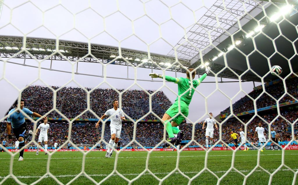 SAO PAULO, BRAZIL - JUNE 19: Luis Suarez of Uruguay scores his team's first goal past goalkeeper Joe Hart of England during the 2014 FIFA World Cup Brazil Group D match between Uruguay and England at Arena de Sao Paulo on June 19, 2014 in Sao Paulo, Brazil. (Photo by Richard Heathcote/Getty Images)