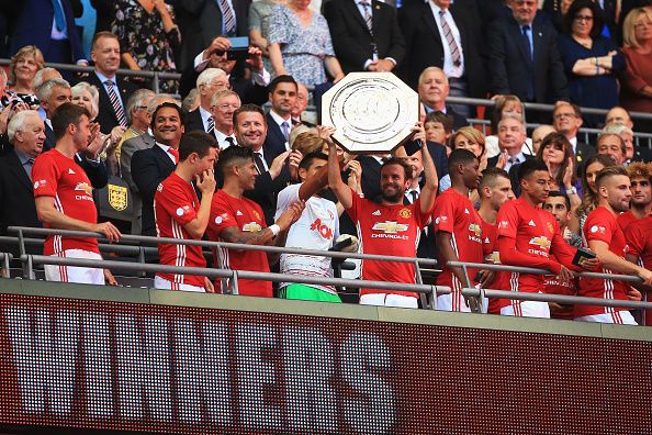 LONDON, ENGLAND - AUGUST 07: Juan Mata of Manchester United lifts the Community Shield trophy during The FA Community Shield match between Leicester City and Manchester United at Wembley Stadium on August 7, 2016 in London, England.  (Photo by Ben Hoskins/Getty Images)