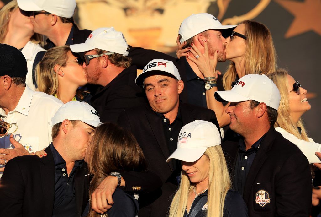 CHASKA, MN - OCTOBER 02: Rickie Fowler of the United States looks on as Kim Johnson, Zach Johnson, J.B. Holmes, Erica Holmes, Jimmy Walker, Erin Walker, Jordan Spieth, Annie Verret, Justine Reed and Patrick Reed celebrate during singles matches of the 2016 Ryder Cup at Hazeltine National Golf Club on October 2, 2016 in Chaska, Minnesota. (Photo by Sam Greenwood/Getty Images)