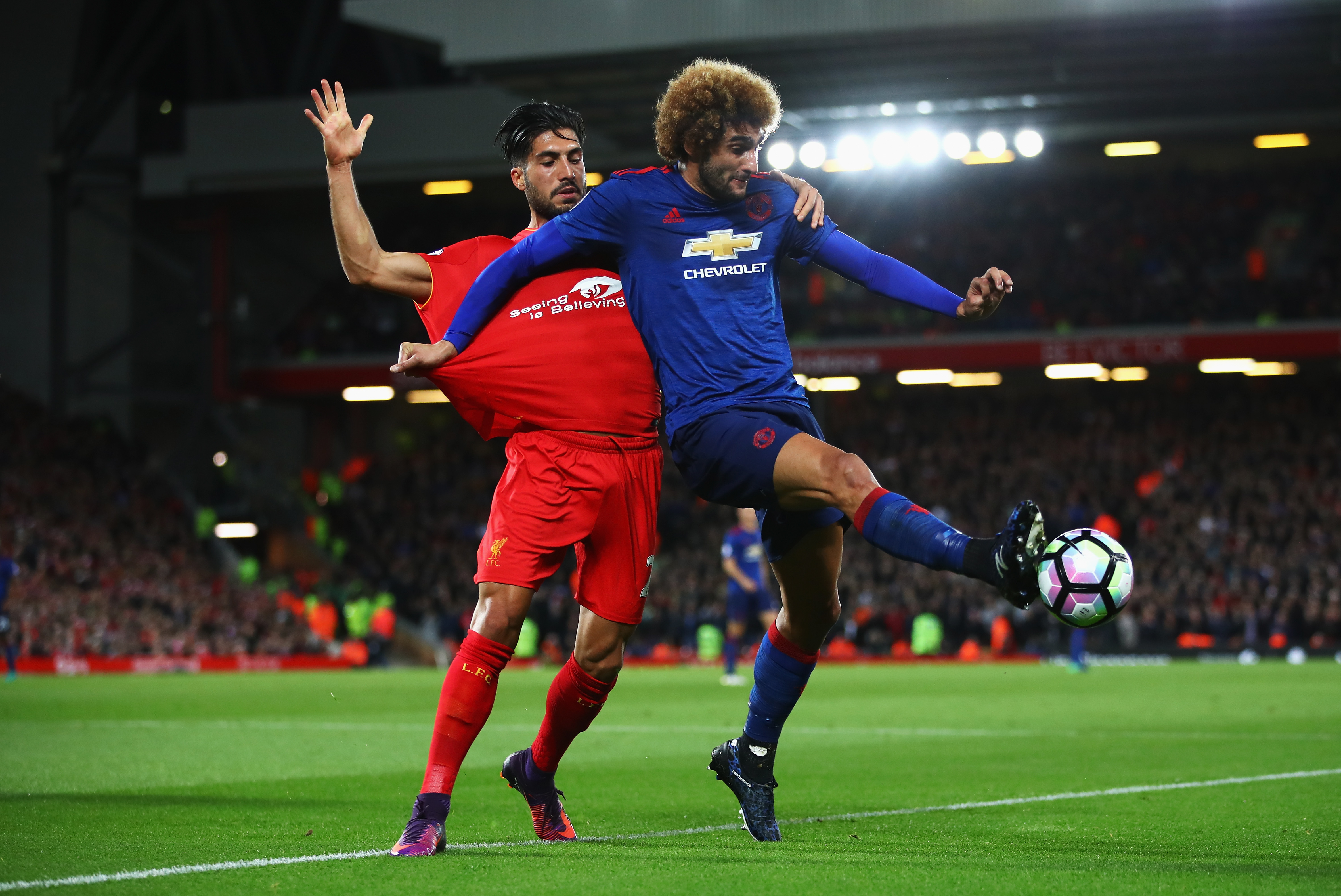 LIVERPOOL, ENGLAND - OCTOBER 17: Marouane Fellaini of Manchester United is closed down by Emre Can of Liverpool during the Premier League match between Liverpool and Manchester United at Anfield on October 17, 2016 in Liverpool, England. (Photo by Clive Brunskill/Getty Images)