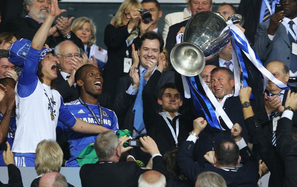 MUNICH, GERMANY - MAY 19: Club owner Roman Abramovich (R) lifts the trophy in celebration while Chancellor of the Exchequer George Osborne (C) applauds after their victory in the UEFA Champions League Final between FC Bayern Muenchen and Chelsea at the Fussball Arena M?nchen on May 19, 2012 in Munich, Germany. (Photo by Alex Livesey/Getty Images)