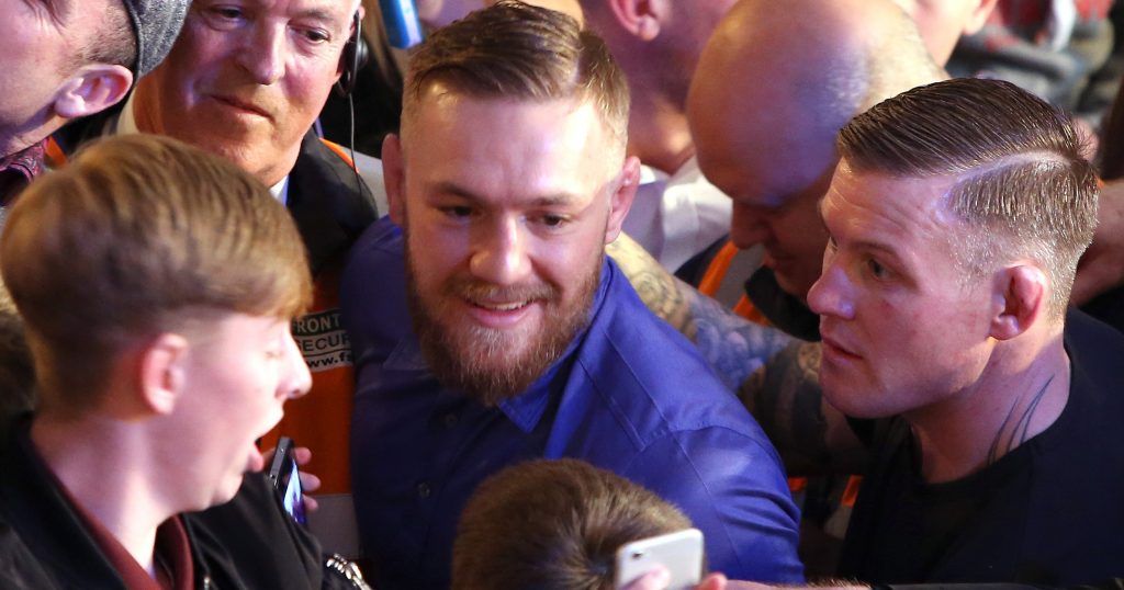 Conor McGregor poses with fans at the event 7/11/2015