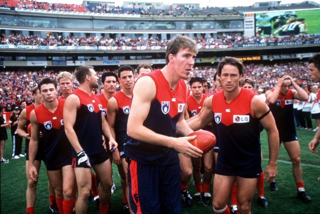 AFL Melbourne Demons 27/3/1999 Jim Stynes is honoured by team mates during the round 1 of the AFL season  ©INPHO/Getty Images