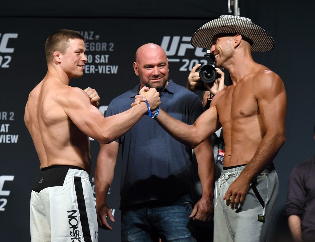 LAS VEGAS, NV - AUGUST 19: UFC President Dana White (C) looks on as mixed martial artists Rick Story (L) and Donald Cerrone (R) shake hands as they face off during their weigh-in for UFC 202 at MGM Grand Conference Center on August 19, 2016 in Las Vegas, Nevada. The fighters will meet in a welterweight bout on August 20, 2016, at T-Mobile Arena in Las Vegas. (Photo by Ethan Miller/Getty Images)